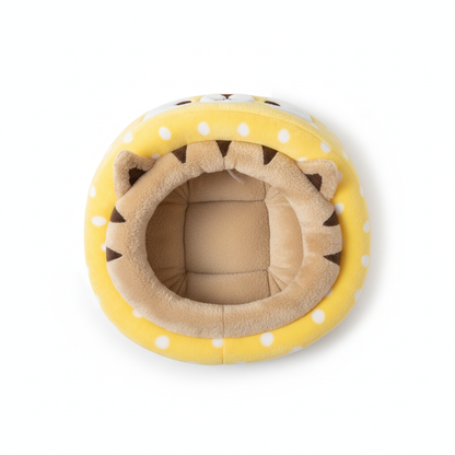 Top-down view of yellow plush cat cave bed showing cushioned interior on white background