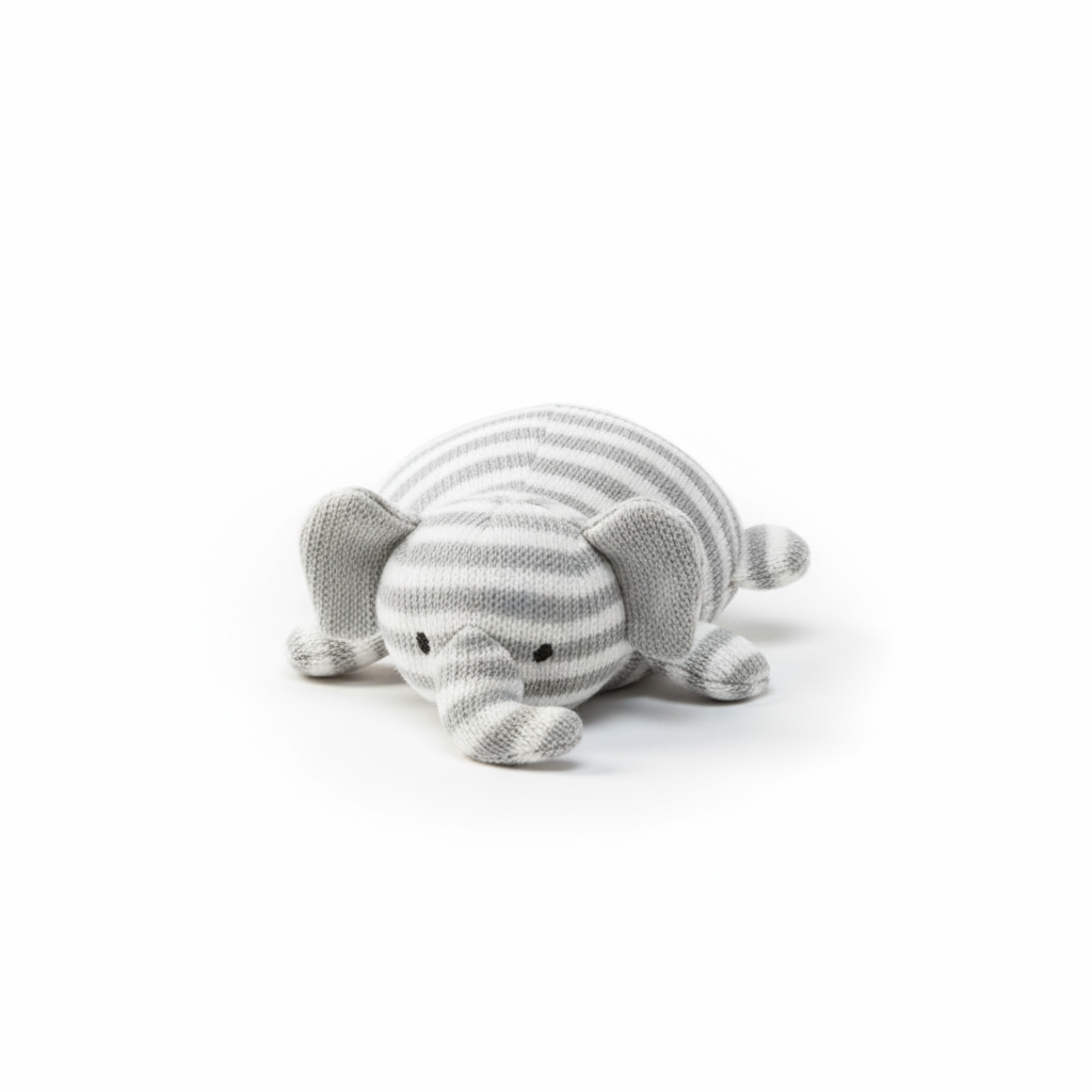 Flat-lay of a striped grey and white plush cat dog toy on white surface